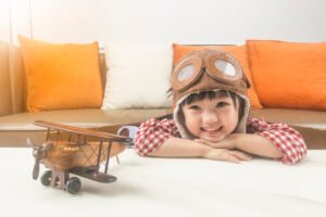 Chinese kid role play as a pilot while looking at his toy plane