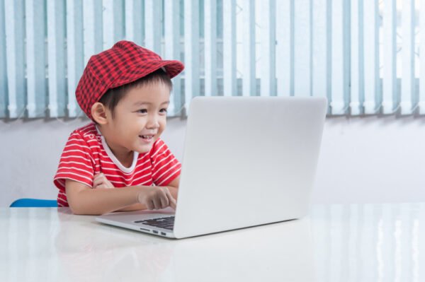 chinese boy using the laptop for online learning