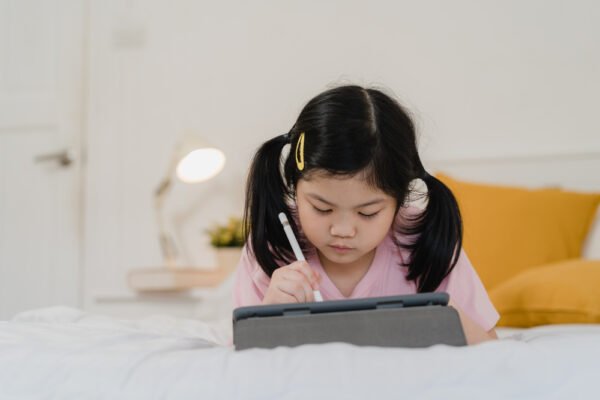 chinese girl learning to write words on her tablet